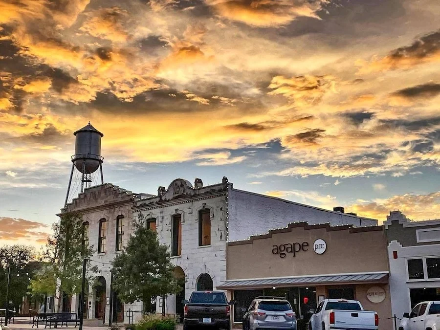 Historic buildings and water tower in downtown Round Rock, Texas at sunset